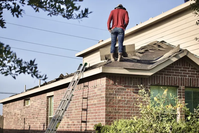 Professional roofer working on a residential roof in Groveville